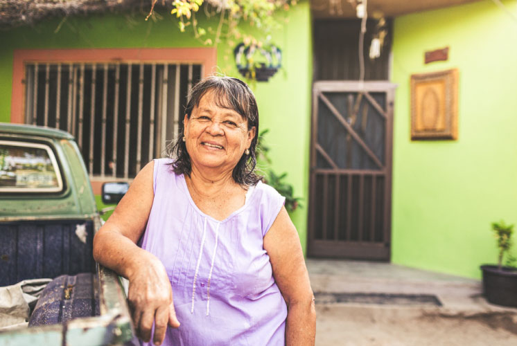 Woman smiling leaning on her truck