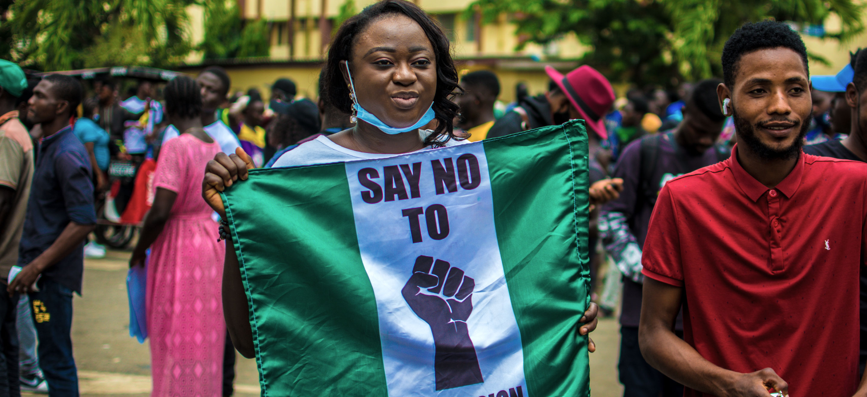 A person holding a banner during a protest in Nigeria.