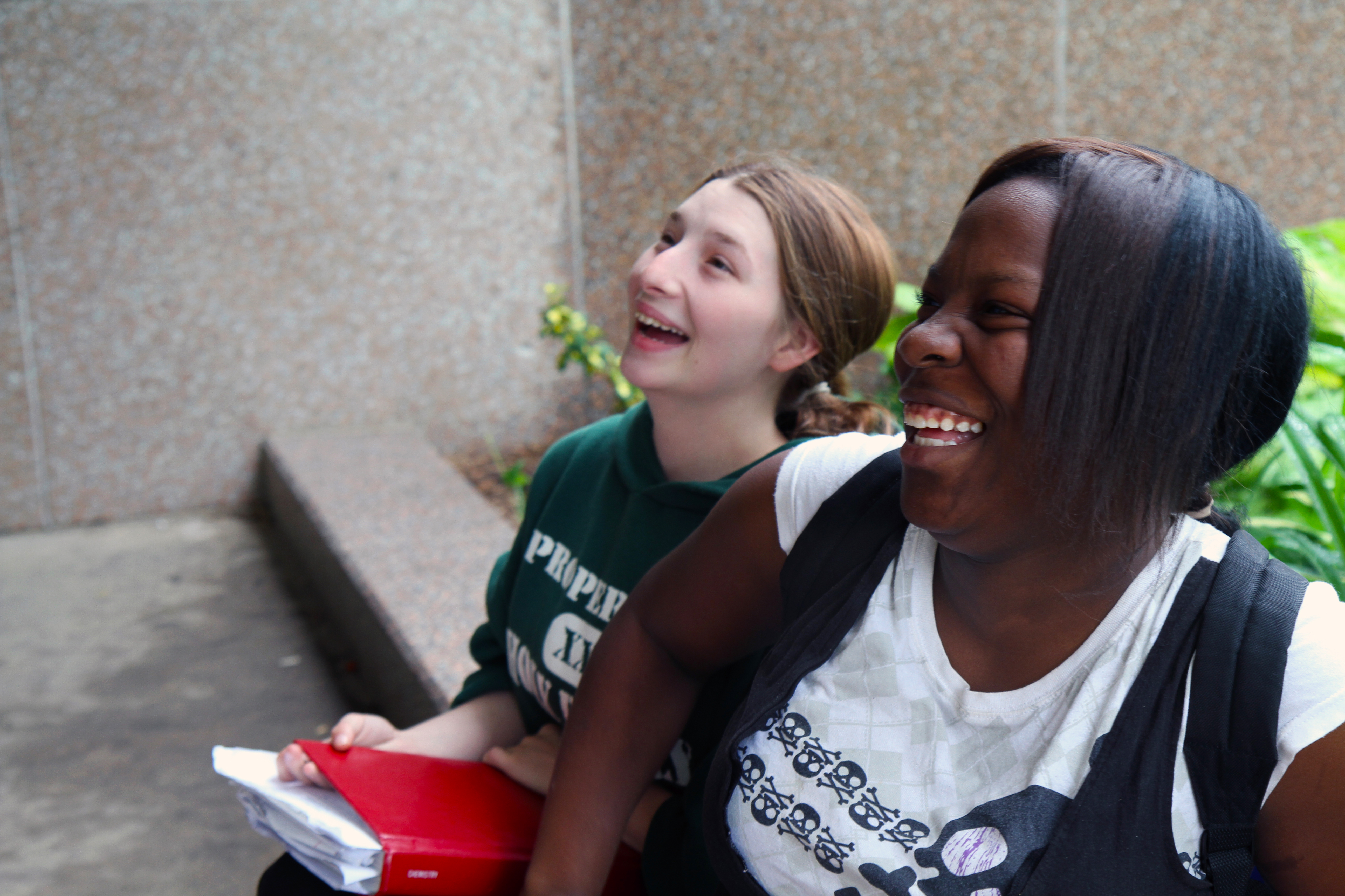 Two young women smiling.