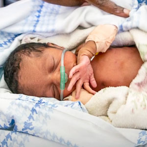 A newborn baby being taken care of.