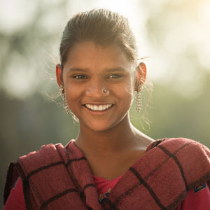A girl smiling in the sun.