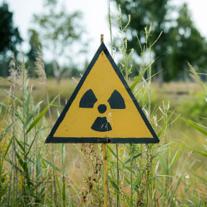 Yellow nuclear materials sign in a field of grass