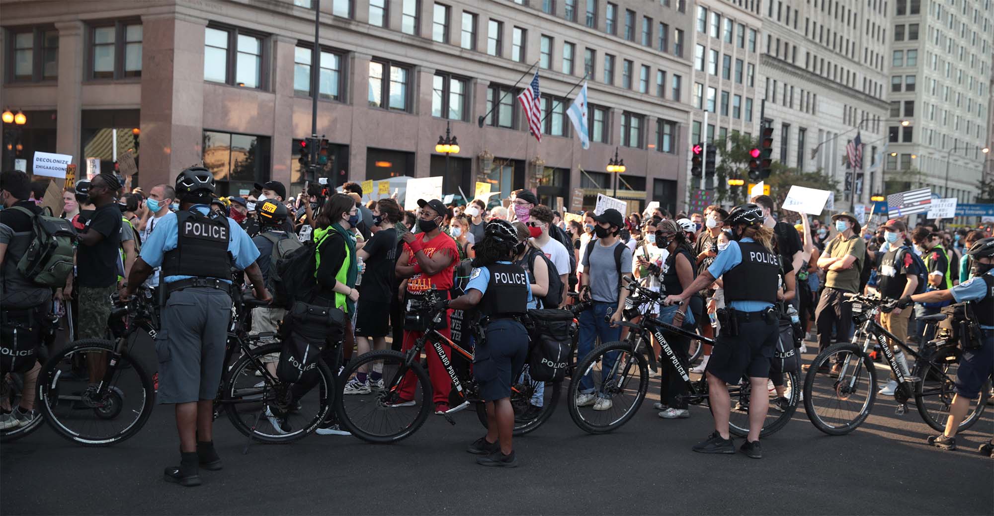Police holding bicycles block the path of demonstrators as they march through downtown Chicago, Illinois. 