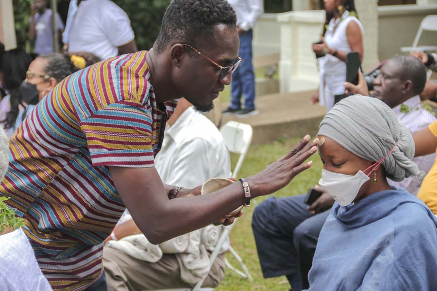 a man anointing the forehead of a woman