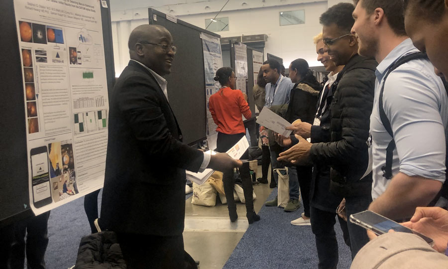 Man handing out flyers to a group of young men