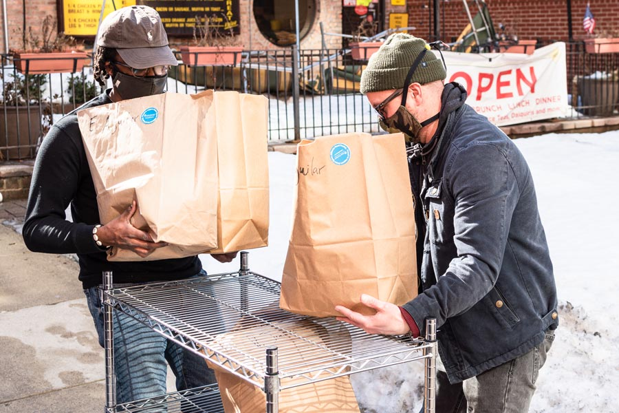 men carrying grocery bags