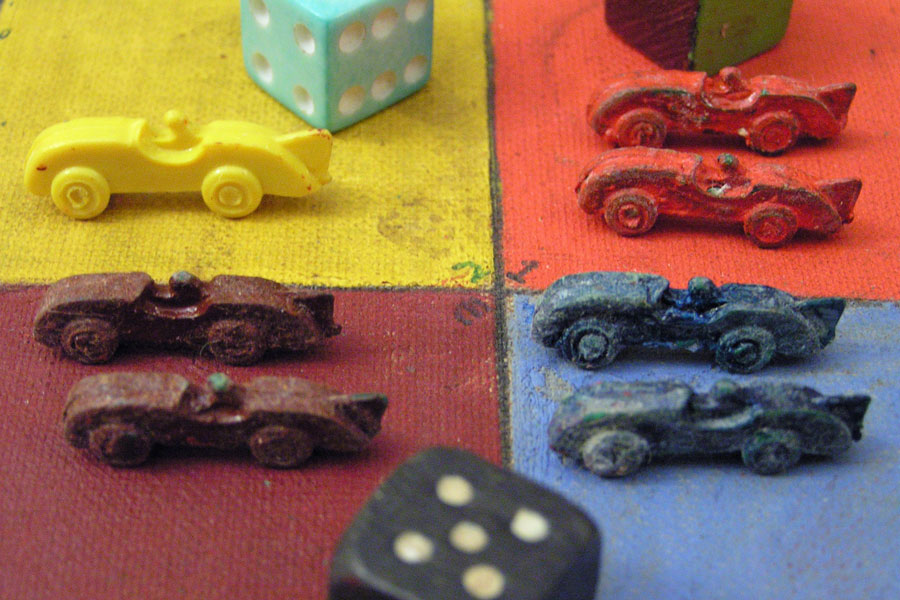 a board game with colourful dice and miniature cars on a board_climate action