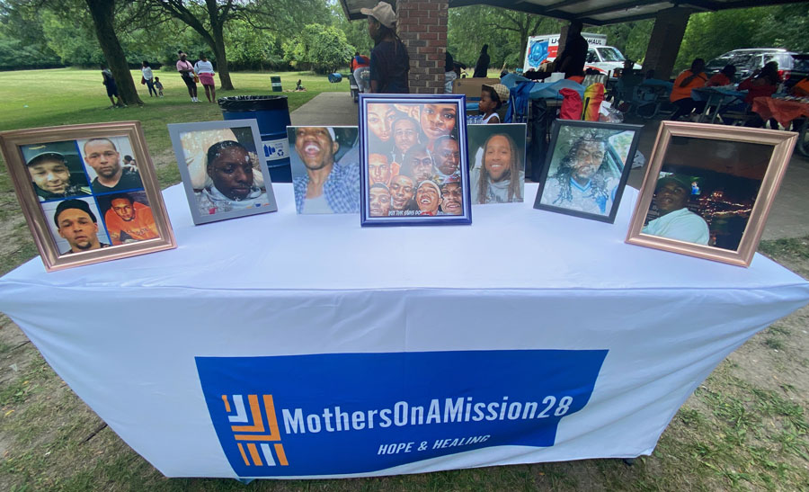 Picture frames on a white table with a banner.