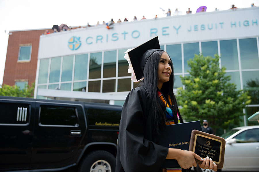 Young woman in black graduation cap and gown