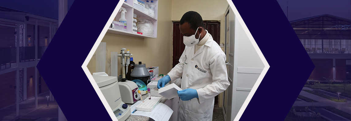 A scientist in white lab coat and blue gloves works in a laboratory, handling scientific equipment.