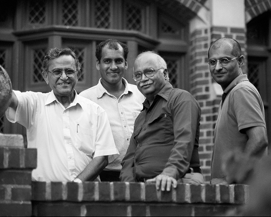 a group of four middle-aged men smiling