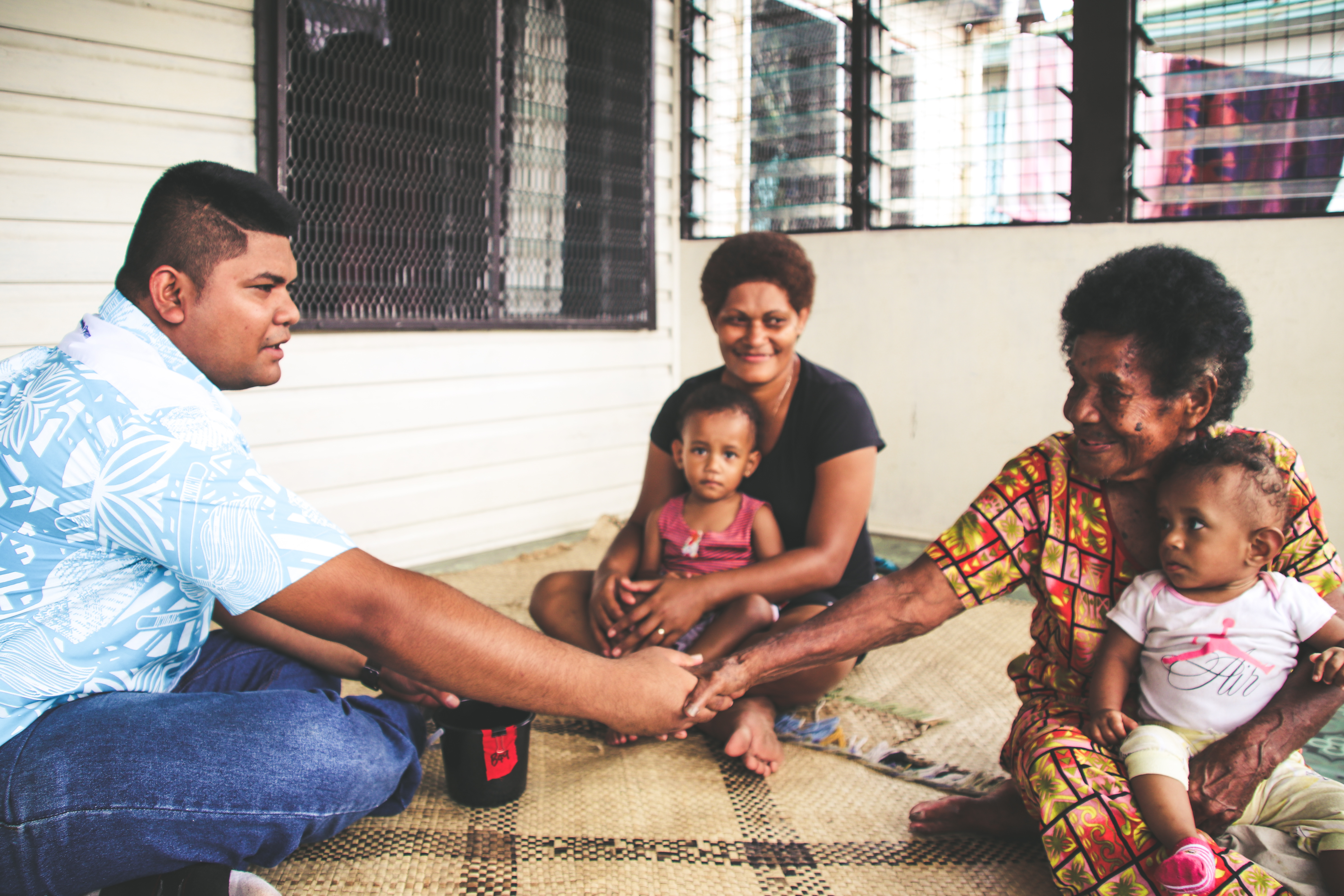 Man sitting with community members in Fiji