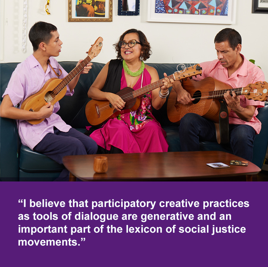 A woman, her son, and husband sit on a couch playing musical instruments