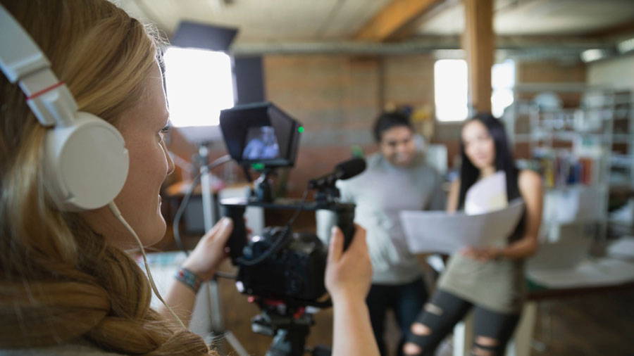 A person filming on a camera.