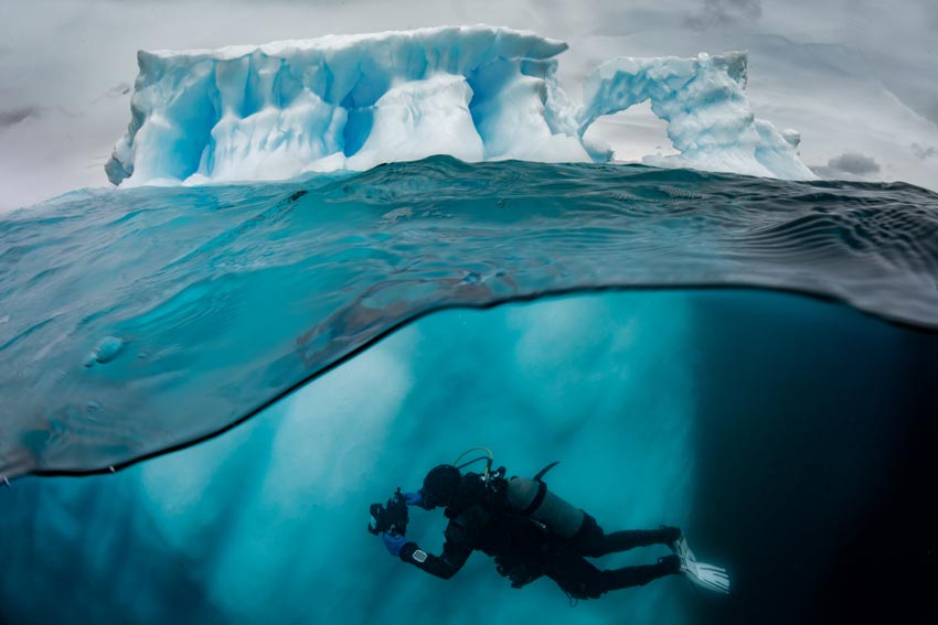 AmemberofthePristineSeasteamswimsunderwatertodocumenttheecosystemaroundtheAntarcticpeninsula.