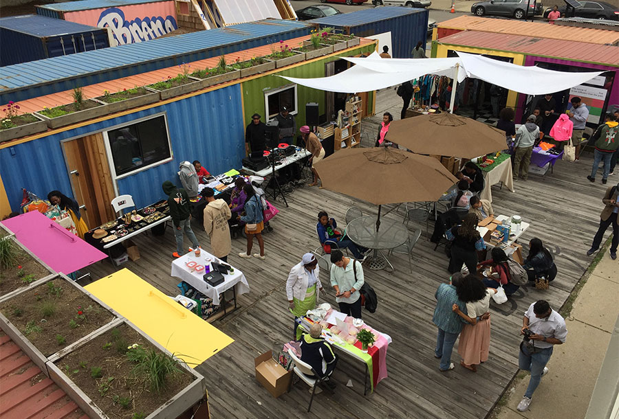 PeopleAtOpenAirMarketMadeFromShippingContainers
