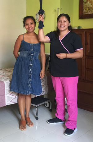Young_Mexican_Midwife_Standing_Near_Bed_With_Young_Pregnant_Mexican_Woman