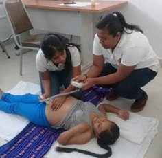Maternal Health Practitioners Examining a Pregnant Woman