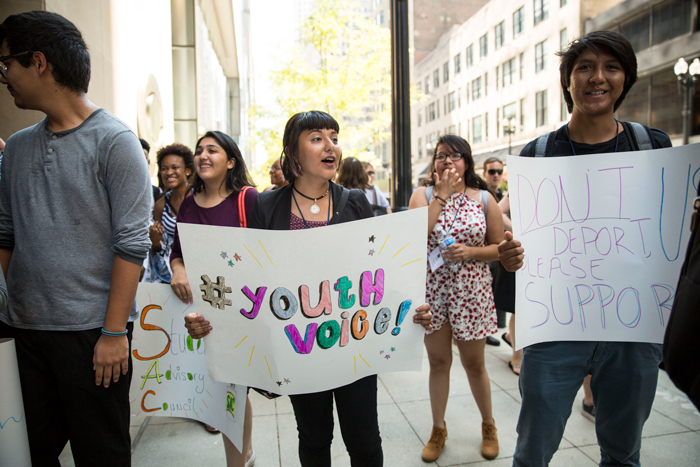 Mikva Challenge youth protesting on the sidewalk