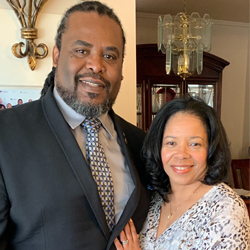 AfricanAmericanManAndWomanStandingInLivingRoom