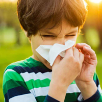 boy sneezing